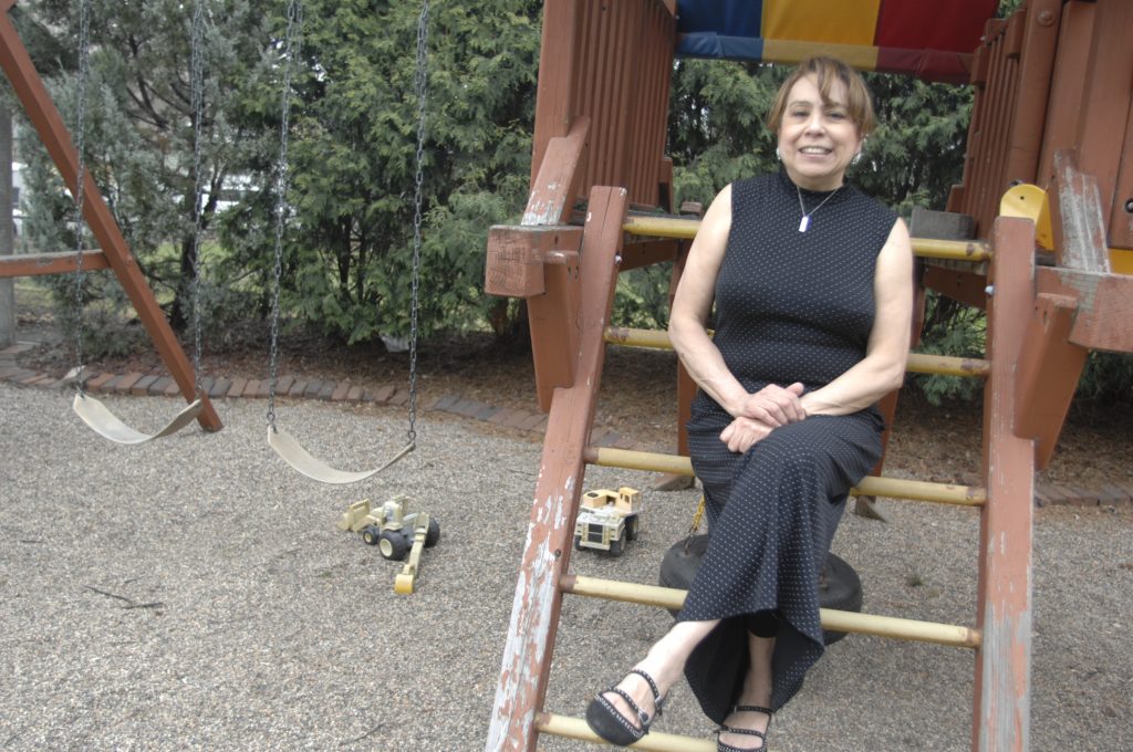 Daycare Provider Rosa Carroll, sitting in the daycare playground.